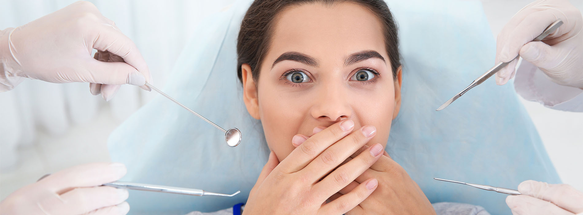 Young woman scared of dental examination in clinic